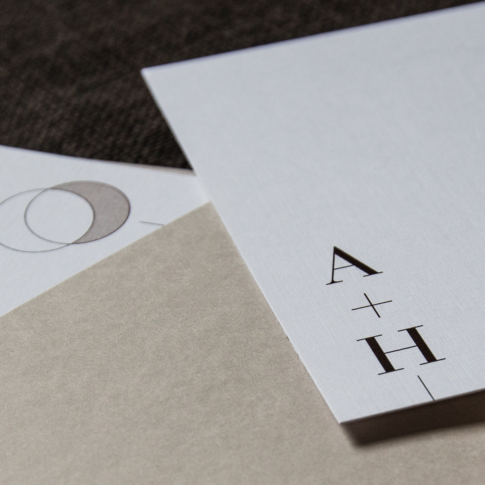Natural brown wedding invitation with a pocket and contemporary fonts and a simple minimalist moon graphic.