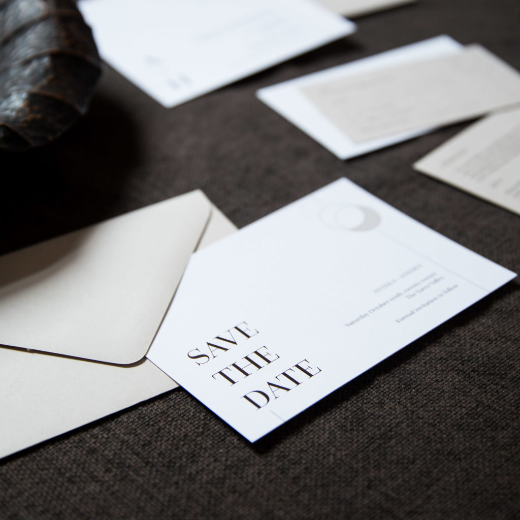 Natural brown stone coloured save the date cards with contemporary fonts and minimalist design