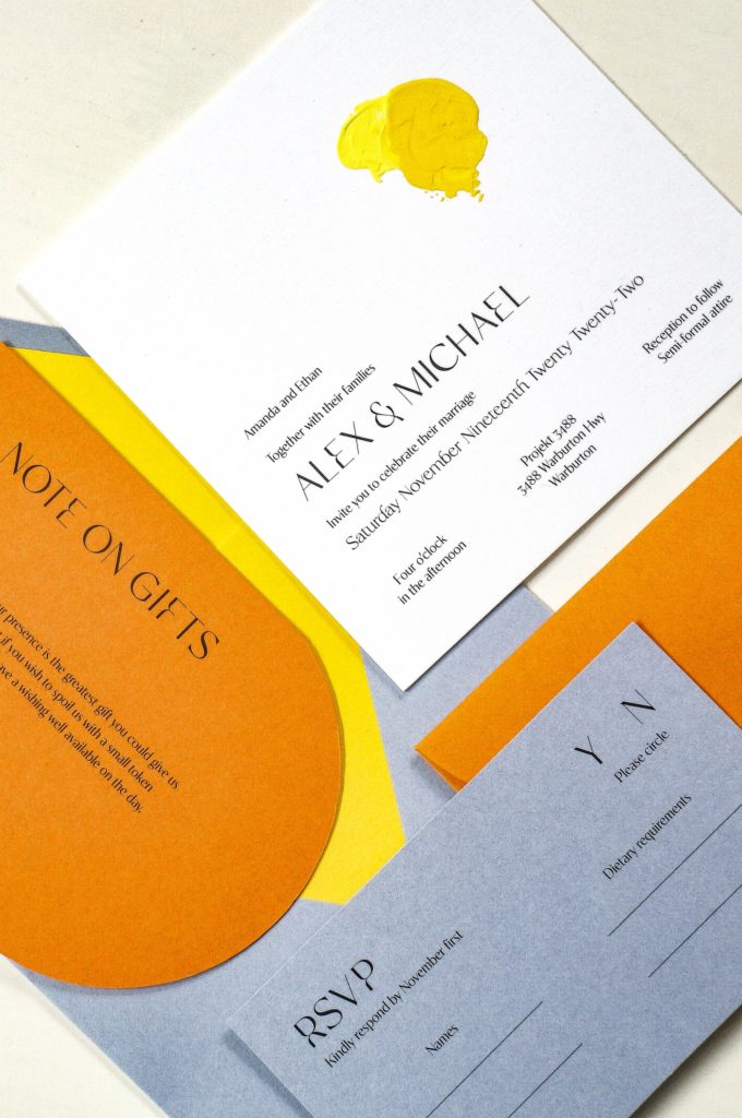 The most unique wedding invitations with hand-painted elements in yellow and orange details card and blue RSVP card