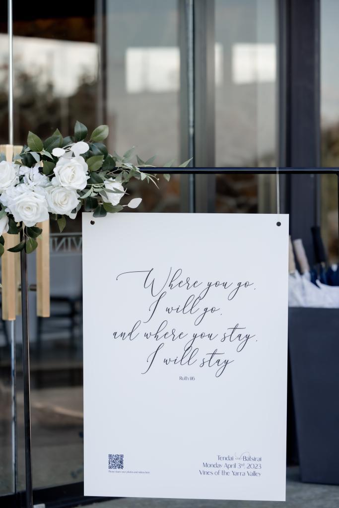 Wedding welcome sign with scripture and QR code.