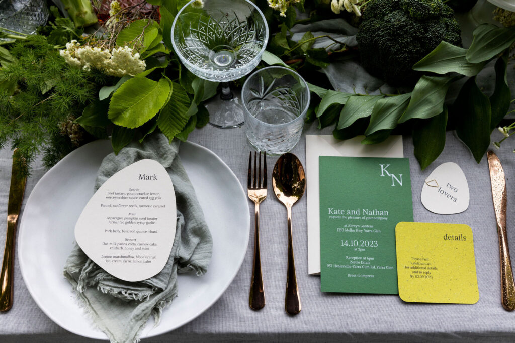 Natural wedding invitations suite with green invitations cards and stone-coloured wedding menus with guest names.