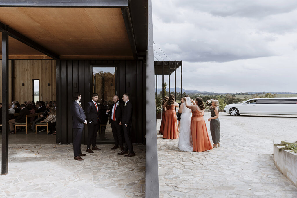 Melbourne wedding photographer Ada and Ivy took an epic shot at Zonzo Estate with the two parties next to each other but separated by a partition.